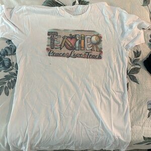 Teacher T-Shirt says “Teacher Peace Love Teach”
